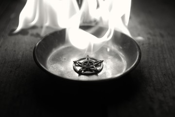 Old pentagram burning in flames