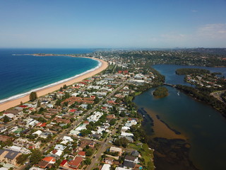 Aerial view of Narrabeen Lake, Narrabeen Beach, Collaroy Beach and Long Reef Head. Sydney CBD in the background.
