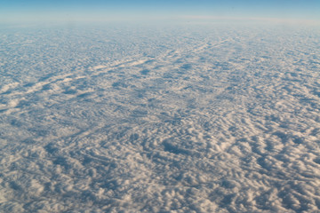 View from airplane on white thick clouds sky
