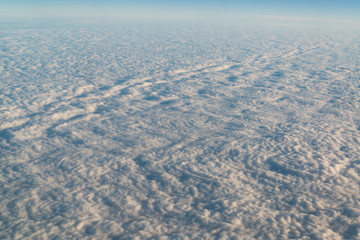 View from airplane on white thick clouds sky