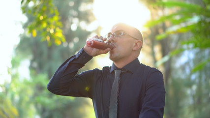 Late 20s Office Worker Drinking Healthy Smoothie in Park