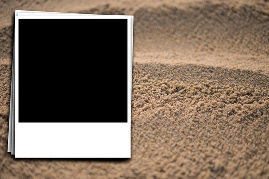 preparation of an instant photo on the background of sea sand