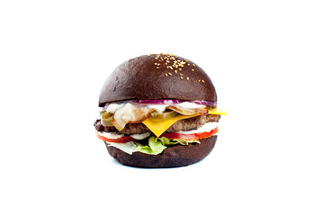 huge appetizing juicy Burger with bacon, beef cutlet, fresh salad, tomatoes, onions, sauce, cheese and black fresh bun with sesame seeds