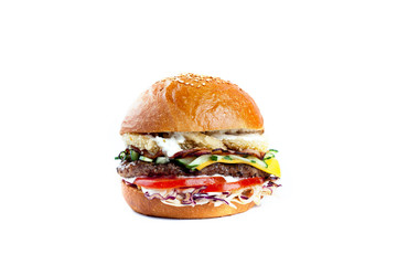 huge appetizing juicy Burger with bacon, beef cutlet, onion rings in breaded, fresh salad, tomatoes, sauce, cheese and white fresh bun with sesame seeds
