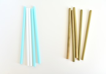 Bamboo and plastic straws on white background. Alternative choice, zero waste, eco friendly lifestyle