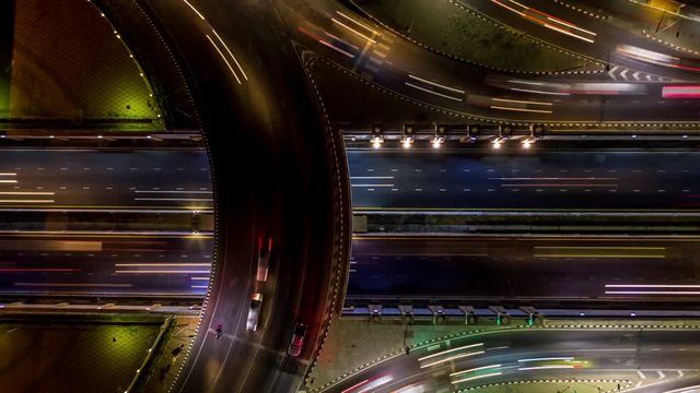4K Time Lapse Aerial view road roundabout intersection in the city at night with vehicle car light movement.