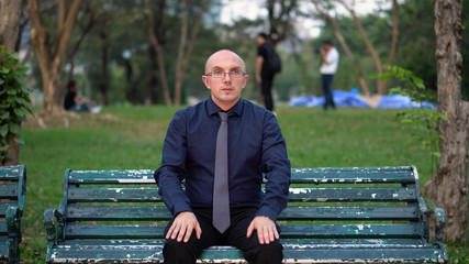 Nervous Late 20s Man Waiting For Date on Park Bench 