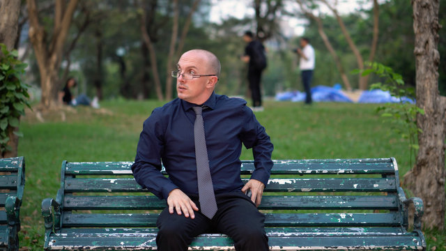 Nervous Late 20s Man Waiting For Date on Park Bench 