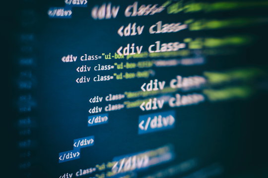 CSS, JavaScript and HTML usage. Monitor closeup of function source code. Abstract IT technology background. Software source code.