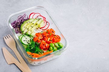 Poke meal prep containers with salmon, rice, radish, cucumber and avocado.