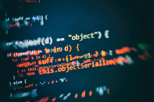 HTML5 in editor for website development. Website HTML Code on the Laptop Display Closeup Photo.