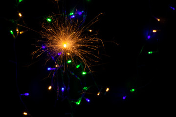 sparkler with blur new year's light close up