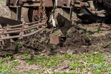 old small tractor harrow field in spring, Caucasus. Karachay-Cherkessia Russia