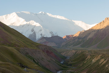 Osh, Kyrgyzstan - Aug 20 2018: Morning Sunlight Landscape of Lenin Peak (7134m) at Alay Valley in Osh, Kyrgyzstan. Pamir mountains in Kyrgyzstan.