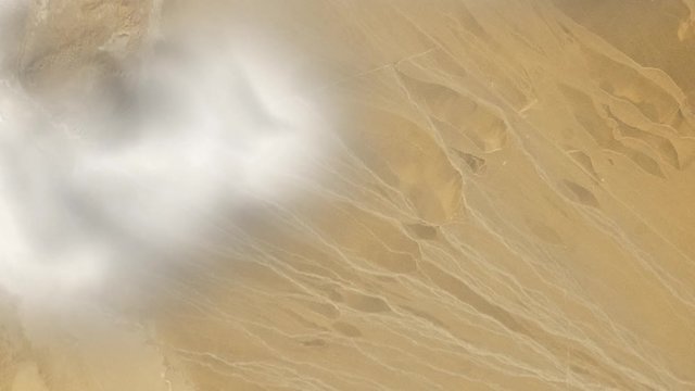 Alluvial fan satellite view in Taklimakan  desert with animated clouds. Contains public domain image by Nasa