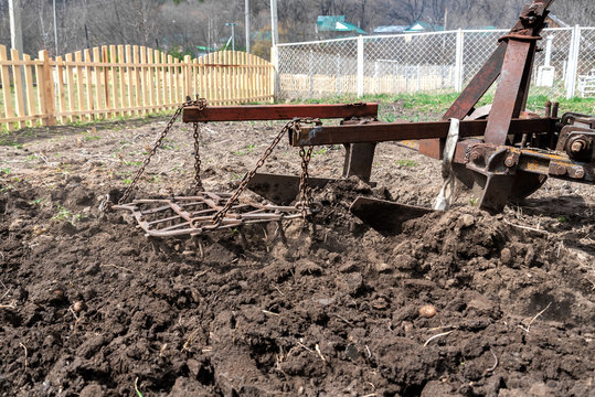 old small tractor harrow field in spring, Caucasus. Karachay-Cherkessia Russia
