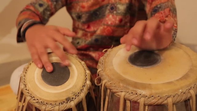 Man playing on a Bongo drum close up. Hand tapping a Bongo drum in close up. Drums hands, movement, rhythm. Goa state, Arambol beach. India