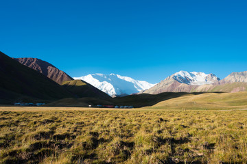 Osh, Kyrgyzstan - Aug 20 2018: Morning Landscape of Lenin Peak (7134m) at Alay Valley in Osh, Kyrgyzstan. Pamir mountains in Kyrgyzstan.