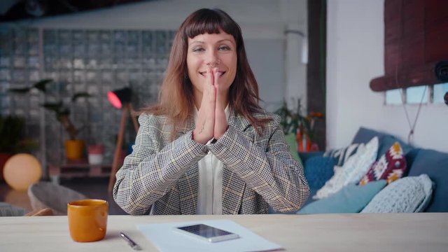 Portrait of elegant smiling business female working on mobile phone device, achieving work goals, make a gesture of expectation and hope, scrolls though new business application,
