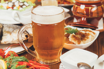 Kraft light unfiltered beer in a glass with foam