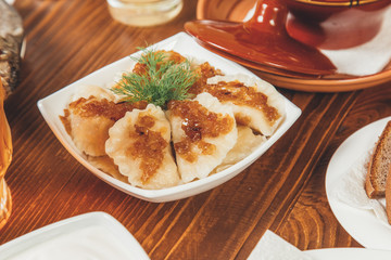Dumplings with potatoes and onions with sour cream