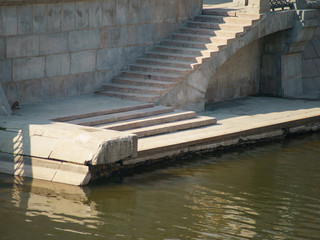 Image of the stone embankment with a stairs descent to water
