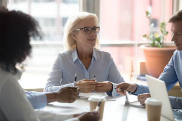 Mature old business leader at diverse team board corporate meeting