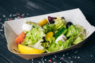 Greek salad with veal in a box
