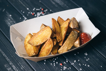  Baked potatoes.Snack in paper eco-friendly boxes. Takeout food in a paper box. Fast food on the street. To go Snacks.