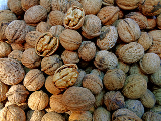 Pile of Raw Walnuts with Nutshells for Sale at the Local Market