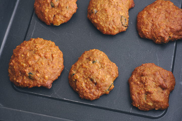 Homemade oatmeal cookies with raisins in a baking tray