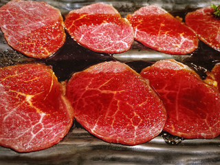 Fresh Raw Sliced Beef on Black Plate