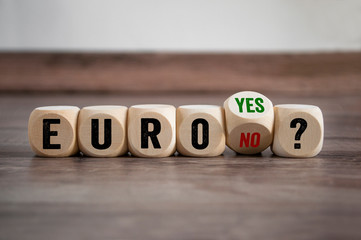 Cubes dice with Euro yes or no on wooden background