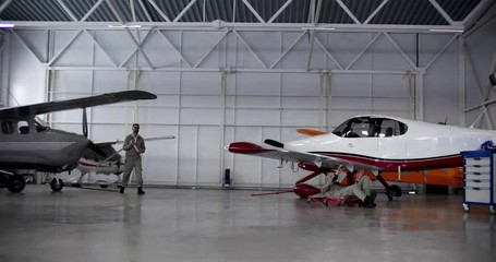 Aircraft maintenance technicians meeting in hangar