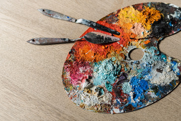 Artist's studio - closeup detail of a colourful palette with paint on