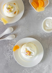 Cottage cheese dessert with apricot filling decorated with whipped cream. 