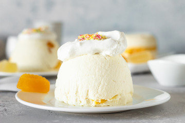 Cottage cheese dessert with apricot filling decorated with whipped cream. 