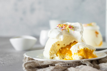 Cottage cheese dessert with apricot filling decorated with whipped cream. 