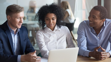 Broker insurer consulting african american clients couple looking at laptop