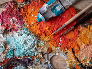 Artist's studio - closeup detail of a colourful palette with paint on