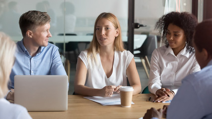 Fototapeta premium Confident female business leader negotiating with clients at group meeting