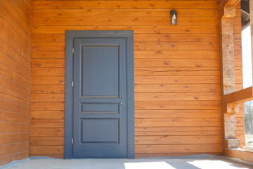 Naklejka na ściany i meble Entrance wooden door on a white background.