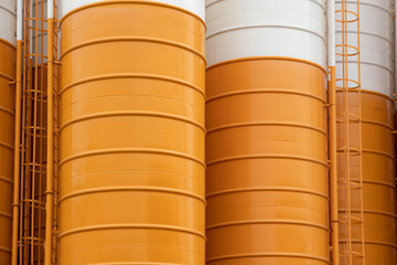 close up yellow steel silos background and texture, metal silos for concrete mix process plant.