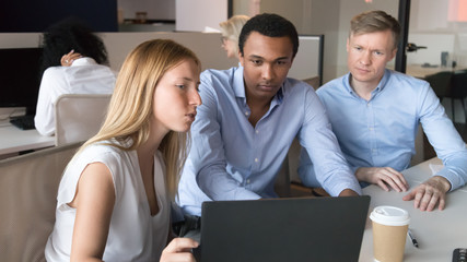 Female manager mentor consulting diverse clients teaching interns with laptop