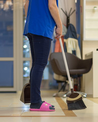 Woman holding a broom. Girls carry a brush with cleaning products. Woman preparing for cleaning
