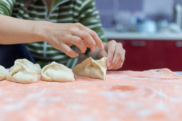 Woman cooks delicious pies (samsa)