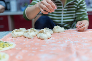 Woman cooks delicious pies (samsa)