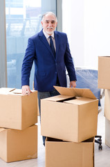 Aged businessman moving to new workplace 