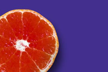 background with a big red tangerine on purple