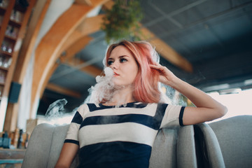 Young woman smoking electronic cigarette. Vape concept.